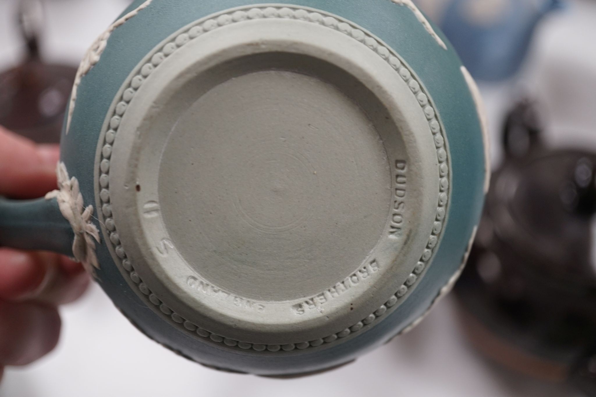 A collection of Dudson stoneware, including jugs, teapots, cream jugs etc, many decorated in low relief